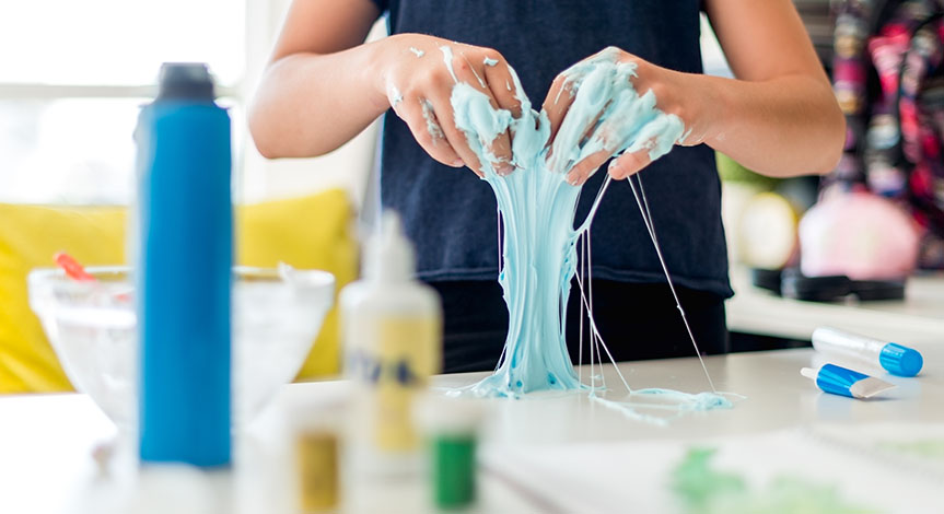 boy mixing the mixture to make Slime