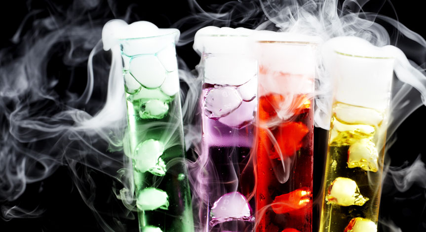 4 test tubes one red, one yellow, one green and one purple with dry ice inside.  